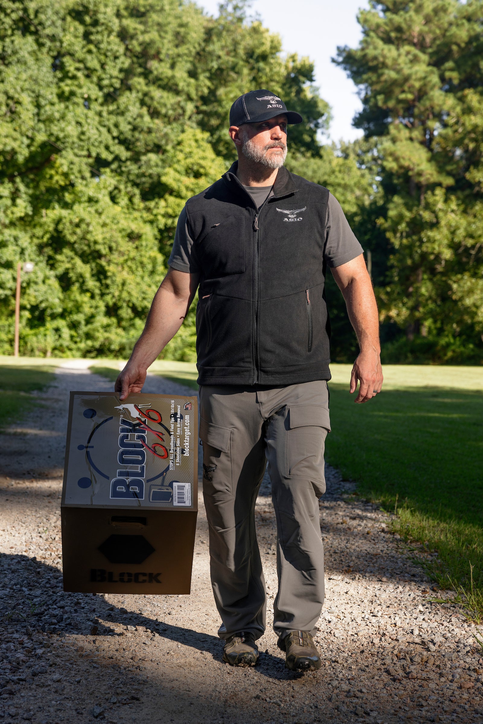 ASIO Gear man wearing black hunting vest with archery target