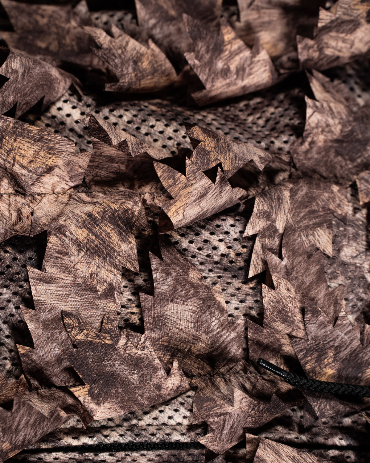 ASIO Gear RAPX camo leafy jacket close up showing 3D leaf cut fabric and breathable mesh construction
